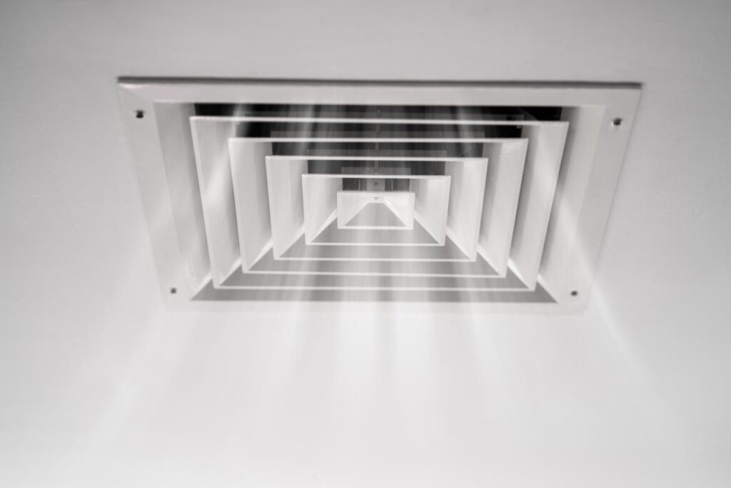 A home ceiling vent releasing air.